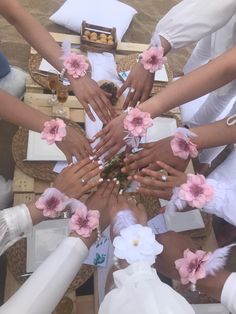 a group of people standing around each other with their hands on top of each other