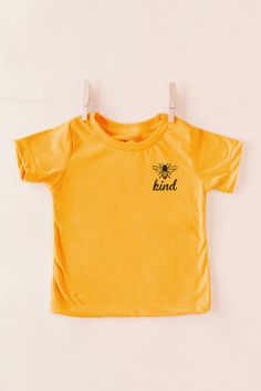 You are sure to be the trendiest mom out there when you wear our adorable neutral hued Shift Tee featuring soft lightweight material, a high rounded neckline, short loose sleeves and a relaxed silhouette that falls into a straight neckline! Pair this with your kiddos for the perfect day out! 100% Cotton This is a Specialty Item and is NOT returnable. This item is made to order and does take additional time to process.Materials may have natural variations Colors may vary from different viewing de Holiday Graphic Tees, Nfl Apparel, Gameday Couture, Trendy Mom, Loose Sleeves, Killin It, The Perfect Day, Kids Graphic Tees, Team Apparel