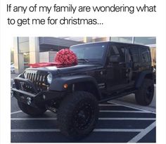 a jeep with a christmas present on the hood