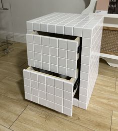 a white box sitting on top of a hard wood floor