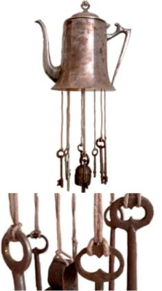 a metal teapot with keys hanging from it's side