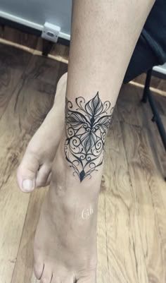 a woman's foot with a tattoo design on the top and bottom of it