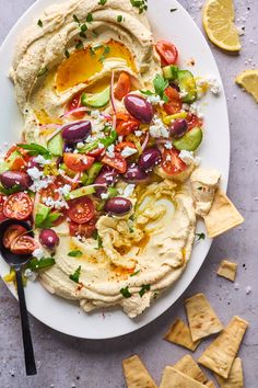 hummus with olives, tomatoes, cucumbers and feta cheese