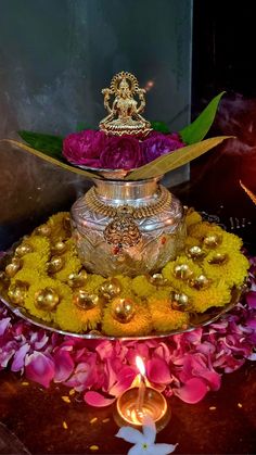 a metal tray with flowers and candles on it