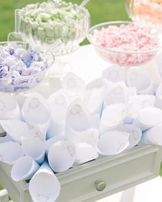 an assortment of candies and cupcakes on display at a wedding or baby shower