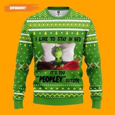 a green sweater with an image of the grin on it and text that says i like to