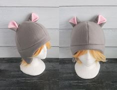 two hats with ears are shown on top of a mannequin's head