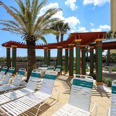 lounge chairs are lined up on the patio