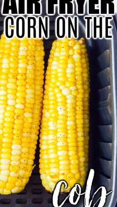 two corn on the cob in a plastic container with text overlay that reads air fryer corn on the cob