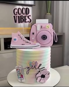 there is a cake that has a camera on it and some decorations in the shape of shoes