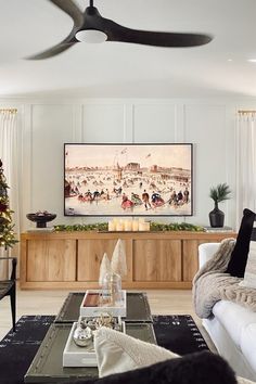 a living room filled with furniture and a flat screen tv mounted to the side of a wall