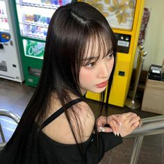 a woman standing in front of a vending machine