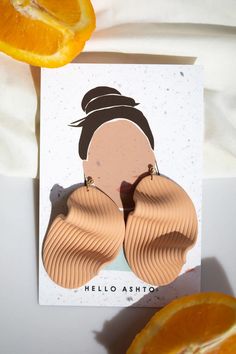 an orange slice next to a card with a woman's face on it