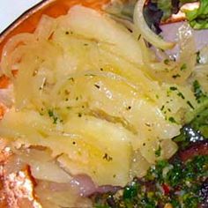 a plate filled with meat and vegetables on top of a table