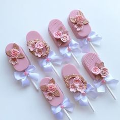 pink and white decorated lollipops with flowers on them