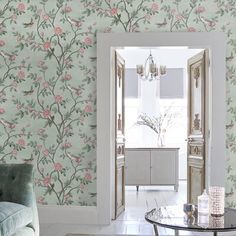 a living room filled with furniture and wallpaper