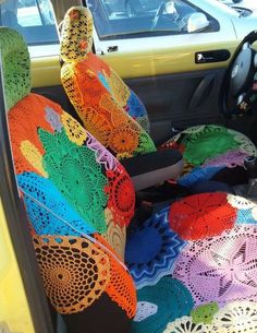 a car seat covered in colorful crocheted material