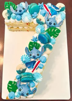 there is a cake shaped like the letter e with blue and green decorations on it