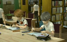 two children sitting at a table with books and papers in front of them, one boy is writing