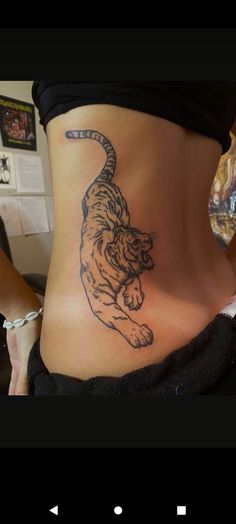 a woman with a tiger tattoo on her stomach