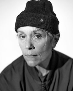 black and white photograph of an older woman wearing a beanie