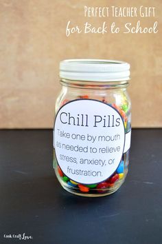 a jar filled with colorful candy sits on a table next to the words, perfect teacher gift for back to school