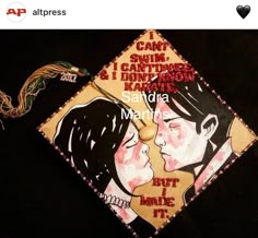 a graduation cap with an image of two people kissing