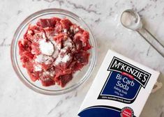 ingredients to make meatloaf in a glass bowl next to a carton of milk