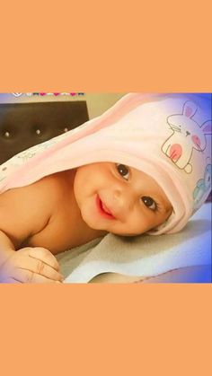 a baby is laying down wearing a pink hat