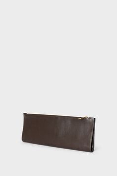 The Slimline in smooth dark brown is the ultimate clutch for a modern minimal aesthetic. Each piece is secured by invisible magnets and opens to pouch size. The 2 in 1 piece exudes a slender, elegant style with a surprisingly functional form. Carry hand-held, folded or flat with a large wallet-like look. Handcrafted exclusively in the A-ESQUE Melbourne Atelier from the finest soft smooth Italian leather. Delivered in an exclusive A-ESQUE cotton drawstring storage bag for preservation and luxury. Minimal Aesthetic, Large Wallet, Clutch Pouch, Italian Leather, Elegant Style, Mini Bag, Soft Leather, Bag Storage, Dark Brown