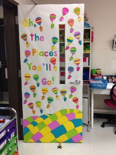 a classroom door decorated with balloons and the words oh the places you'll go