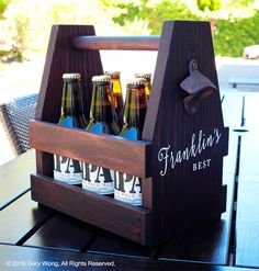 a wooden beer caddy with six bottles in it