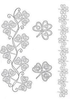 the four leaf clovers are drawn in black and white, with intricate designs on them