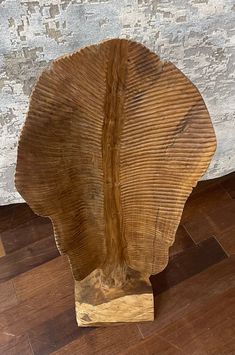 a piece of wood sitting on top of a hard wood floor next to a wall