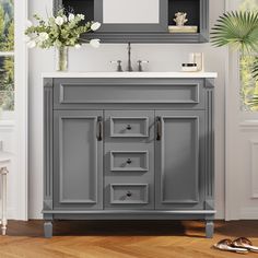 a gray bathroom vanity with white sink and mirror