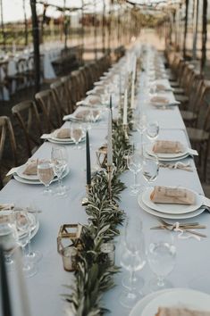 a long table with plates and place settings