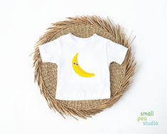 Just like our Yellow Banana Baby Tee but with some silly googly eyes! (The googly eyes are printed, not 3-D, so there is no chance of them falling off!) Baby's first steps should be done with style, and this crew neck t-shirt is here to help. For children--it's super-soft and comfortable. For parental figures--it's shrink-resistant and durable. All of that is made possible with the pre-shrunk, 100% airlume combed and ringspun cotton (Athletic Heather: 90/10 airlume combed and ringspun cotton-polyester blend; Additional Heather colors: 52/48 airlume combed and ringspun cotton-polyester blend). .: 100% airlume combed and ringspun cotton (fiber content may vary for different colors) .: Light fabric (4.2 oz/yd² (142 g/m .: Regular fit .: Tear-away label Playful White T-shirt With Smiley Face, Yellow Funny Print T-shirt, Yellow T-shirt With Funny Print, Playful Summer T-shirt For Gift, Playful Summer T-shirt As A Gift, Playful Summer T-shirt As Gift, Playful Summer T-shirt Gift, Summer T-shirt With Cartoon Print For Gift, Playful Summer T-shirt With Funny Text