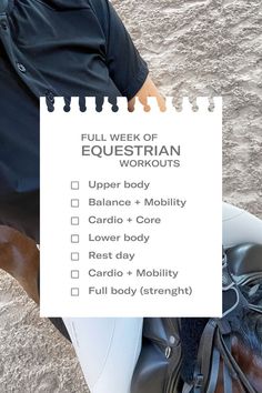 a man sitting on top of a horse next to a white sign that says full week of equestrian workouts