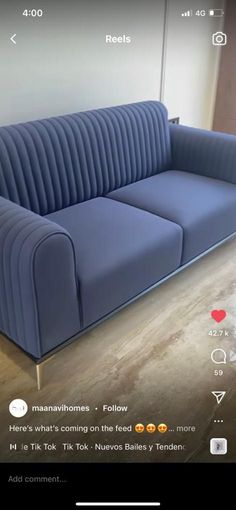 a blue couch sitting on top of a wooden floor