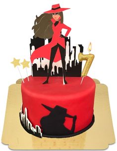 a red and black cake with a woman on it's top, surrounded by stars