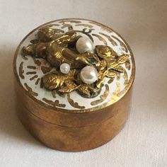 an ornately decorated wooden box on a white surface