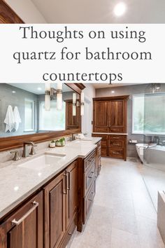 a large bathroom with wooden cabinets and marble counter tops, along with the words thoughts on using quartz for bathroom counters