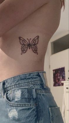 a woman with a butterfly tattoo on her stomach