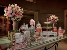 a table filled with lots of candy and flowers