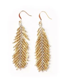 Designed after our best-selling Devon Earrings, the Uranise Earrings feature more gold than silver, which make them a better fit for our Devon-lovers that also love gold!  The intricate bead work on these earrings is second to none and takes on the look of a feather.   Uranise is one of talented Haitian jewelry artisans.  She tells us of her upbringing, "I was born and raised in Source Matela, Haiti. My father worked to raise my older sister and I. He lost his job when I started high school. I had come too far to stop going to school, so I started to work as a vendor in the market to pay for school. When I graduated high school, I wasn't able to pay for university because it was much more expensive. This led me to finding a job with Vi Bella."  When asked what brings her joy, she answered, Haitian Jewelry, Older Sister, Handmade Beaded Jewelry, Beaded Jewelry Patterns, Ear Rings, My Father, Christmas Gifts For Women, Feather Earrings, Fringe Earrings