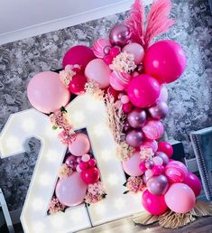 a large number decorated with balloons and flowers