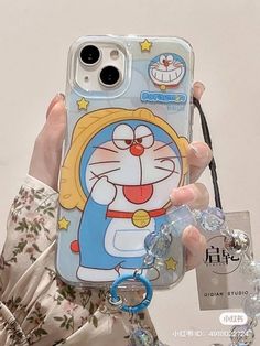 a person holding up a phone case with a cartoon character on it