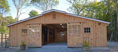 an open garage with two doors and windows