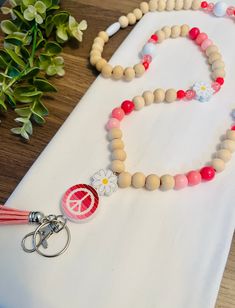 Peace☮️Love💕Learn📓 The cutest lanyard for any special teacher in your life! ✺ Beaded Lanyard, Teacher Lanyard, Wood Bead Lanyard ✺ Bead Size - 12mm  ✺ Lanyard length approx.  ✺ All items are made in a smoke-free home ✺ Secured with a breakaway clasp for connivence and safety!  ✺ Ships throughout the USA from Georgia! ✺ Processing & Shipping: Please allow 3 days for production, although I will try my best to have it be much sooner. USPS estimates you will receive it in 3-5 business days (U.S.) Pink Beaded Lanyards For Gifts, Adjustable Personalized Pink Lanyard, Handmade Pink Beaded Lanyards, Diy Beaded Lanyards, Wood Bead Lanyard, Teacher Lanyard Beaded, Bead Lanyard, Lanyard Teacher, Cute Lanyards