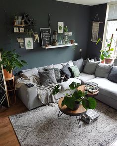 a living room filled with furniture and plants